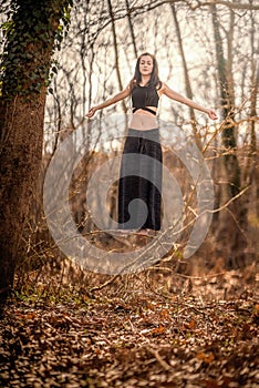 Almost Levitation... Woman standing on a very thin tree`s branch