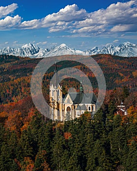 Levoca, Slovakia - Aerial view of Basilica of the Blessed Virgin Mary on a bright autumn day with the snowy summit of Marianska photo