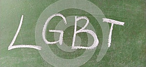 LGBT abbreviation written in white chalk on a green school board. Diversity of sexuality and gender identity based on culture.