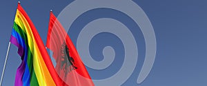 LGBT and Albania flags on flagpole on blue background. Rainbow flag. Place for text. Tirana. LGBT community. 3d illustration