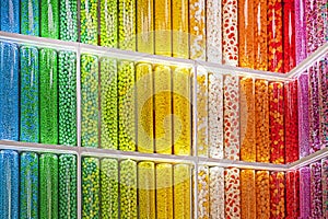 LGBT background of colorful rainbow sweets in transparent containers