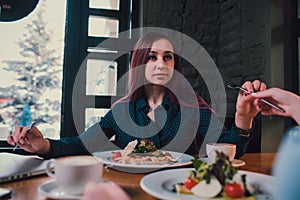 LGBT Cheerful female friends chatting in cafe. Two beautiful young women gossiping and drinking coffee. Friendship