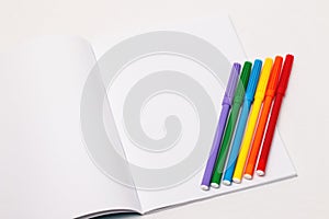 LGBT flag with markers on blank notebook photo