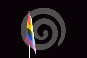 LGBT flag in rainbow colors. Black background. The concept of love, independence and freedom for gay people, homosexuals, lesbians