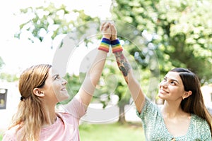 LGBT friends supporting gay rights with rainbow bracelets