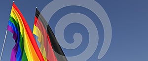 LGBT and German flags on flagpole on blue background. Rainbow flag. Place for text. LGBT community. German. 3d illustration