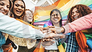 Lgbt group of people stacking hands outside