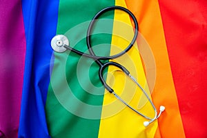 LGBT Health care. Medical Stethoscope on rainbow pride flag background, overhead view