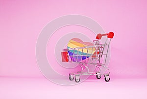 LGBT , LGBTQI Heart paper Pride flag color with Shopping cart on pink background - Love Pattern Sexual diversity - Lesbian gay bis