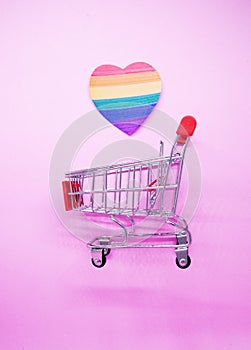 LGBT , LGBTQI Heart paper Pride flag color with Shopping cart on pink background - Love Pattern Sexual diversity - Lesbian gay bis