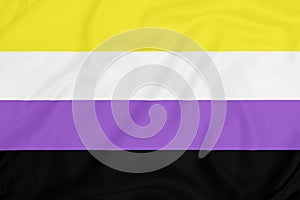 LGBT Non-binary pride community flag on a textured fabric. Pride symbol