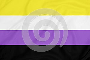 LGBT Non-binary pride community flag on a textured fabric. Pride symbol photo