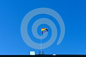 LGBT Pride flag on the top floor of a building