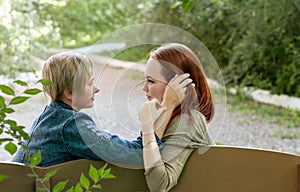 LGBT women. Young lesbian couple walking in the park together. Delicate relationship. Selective focus.