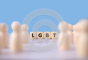 LGBT word on wooden blocks and group of wooden figure on blue background as represent human relationship in cousin.Lesbian Gay