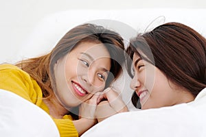 LGBT, Young cute asia lesbians lying and smiling on white bed to