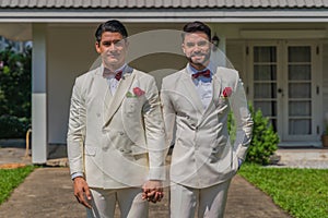 LGBTQ gay couple having goodtime together in wedding ceremony photo