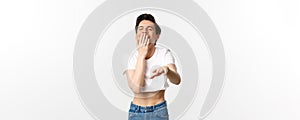 Lgbtq and pride concept. Image of silly gay man in crop top laughing and pointing hand at camera, chuckle over funny