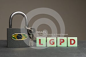 LGPD brazilian data protection law concept: lock with brazil flag on a table with some plastic tiles with the acronym of the photo