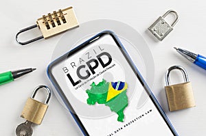 LGPD brazilian data protection law concept: smartphone sorrounded by padlocks with an imaginary page showing a link to read the