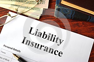 Liability insurance on a wooden table. photo