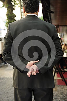 Liar: businessman with fingers crossed photo