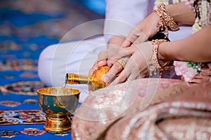 Libation, Thai engagement, pour water in Thai wedding, pouring water in Thai wedding photo