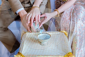 Libation, Thai engagement, pour water in Thai wedding, pouring water in Thai wedding. photo
