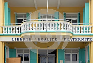 Liberte, Egalite, Fraternite under a balcony