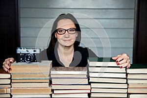 Librarian women in glasses at wall of books archives.