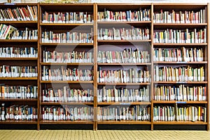 Library with book shelves full of book arranged in order on regals