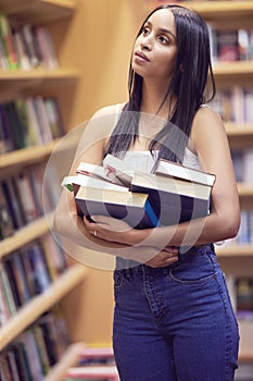 Library, education or university and a woman student looking for books or study material in a bookstore. College