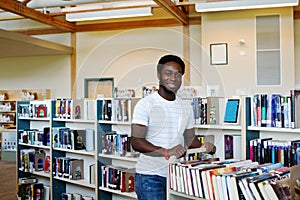 Library employee pushing book cart