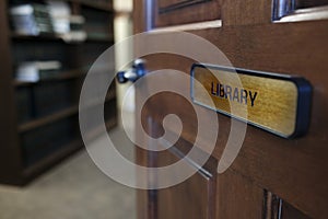 Library Sign on Door Leading to Room with Books on Shelves