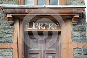 Library sign on stone lintel above door