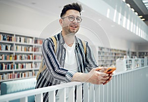 Library, smart student or intelligent man with phd research goals, vision for success and excited for knowledge learning