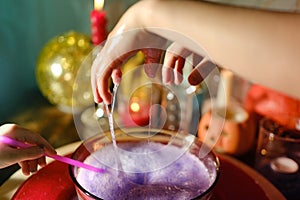 Librate with hands, child making magical gestures over potion, Halloween games, Halloween Rituals, Holiday Prep photo