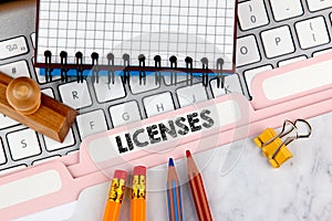 Licenses concept. Folder Register on Background of Computer Keyboard photo