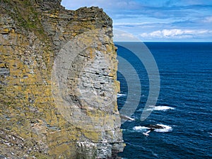 Lichen covered fractured rock strata on Sumburgh Head, south Shetland, UK - part of the Bressay Flagstone Formation