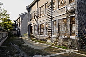 Lichen-covered pavement behind archaised Chinese traditional bui