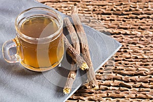 Licorice roots - Glycyrrhiza glabra. Wooden background