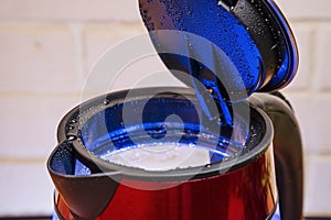 lid of an electric kettle covered with large drops of steam condensate