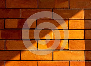 LiDetails of a lght and shadow on the red brick wall texture background.