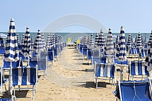 LIDO DI JESOLO, ITALY: Umbrellas on the beach of Lido di Jesolo at adriatic Sea in a beautiful summer day, Italy. On the beach of