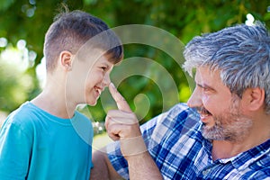 Lie detecting father pushing sons nose