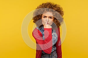 This is lie! Portrait of angry woman with fluffy curly hair touching nose, showing liar gesture, expressing distrust