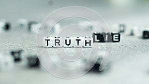 Lie vs. truth in white and black letter bead blocks.