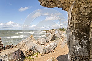 Liepaja, Latvia- July 7, 2023: Ruins of bunkers on the beach of the Baltic sea, part of an old fort in the former Soviet