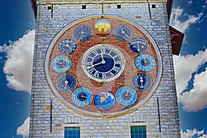 View on medieval tower with 12 clock faces showing metonic moon phases, time, periodic phenomena, solar cycle, tides, seasons