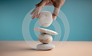 Life Balance Concept. Hand Setting White Natural Zen Stone Stack. Balancing Mind, Soul and Spirit